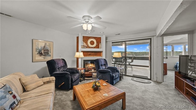 5940 Baydy Peak Rd Unit 325, Osage Beach, MO 65065 - carpeted living room featuring a glass covered fireplace and a ceiling fan