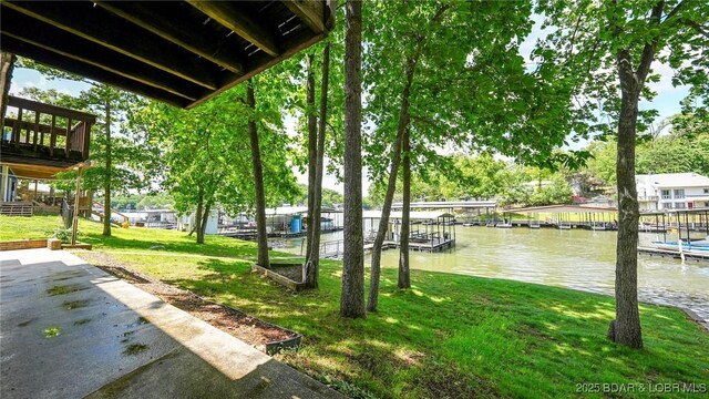 47 Dixie Ln, Sunrise Beach, MO 65079 - view of grassy yard with a water view and a dock