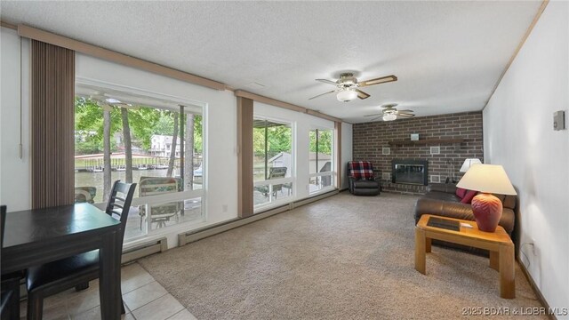 47 Dixie Ln, Sunrise Beach, MO 65079 - living room with ceiling fan, healthy amount of natural light, a brick fireplace, carpet floors, and a textured ceiling