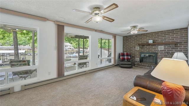 47 Dixie Ln, Sunrise Beach, MO 65079 - carpeted living area featuring a textured ceiling, a fireplace, healthy amount of natural light, ceiling fan, and baseboard heating