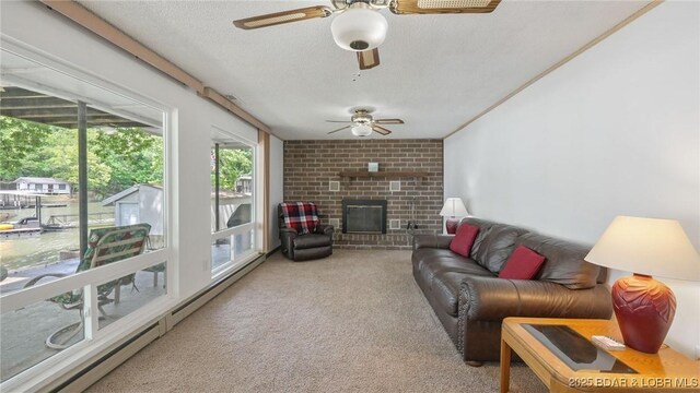 47 Dixie Ln, Sunrise Beach, MO 65079 - carpeted living area featuring a ceiling fan, a brick fireplace, a textured ceiling, and baseboard heating