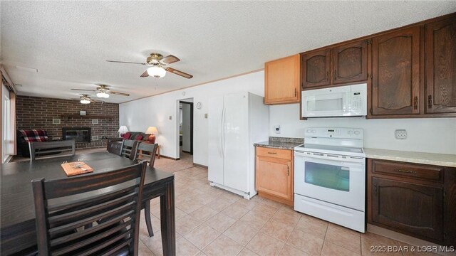 47 Dixie Ln, Sunrise Beach, MO 65079 - kitchen with white appliances, a textured ceiling, a brick fireplace, ceiling fan, and light tile patterned floors