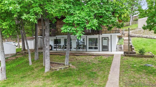 47 Dixie Ln, Sunrise Beach, MO 65079 - rear view of house with a yard, stairs, and a patio area