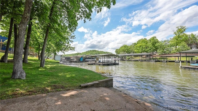 47 Dixie Ln, Sunrise Beach, MO 65079 - dock featuring a water view, boat lift, and a lawn