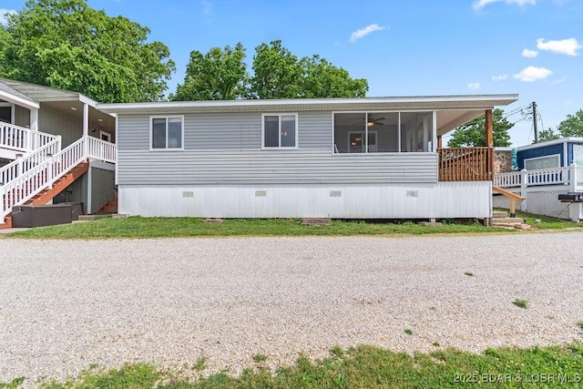 29566 Hunter Rd, Gravois Mills, MO 65037 - manufactured / mobile home with a sunroom, stairs, a ceiling fan, and crawl space