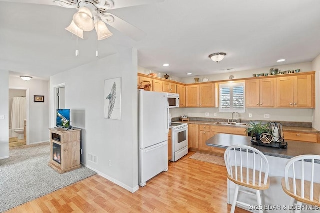 29566 Hunter Rd, Gravois Mills, MO 65037 - kitchen with white appliances, a sink, light wood-style floors, light brown cabinetry, and recessed lighting