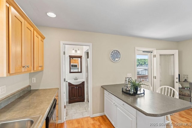 29566 Hunter Rd, Gravois Mills, MO 65037 - kitchen with a peninsula, white microwave, dark countertops, dishwasher, and light wood-type flooring