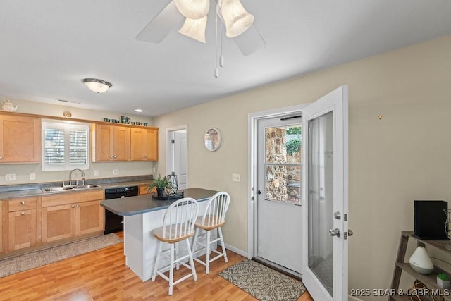 29566 Hunter Rd, Gravois Mills, MO 65037 - kitchen featuring dishwasher, a sink, a breakfast bar, light wood-style flooring, and a ceiling fan