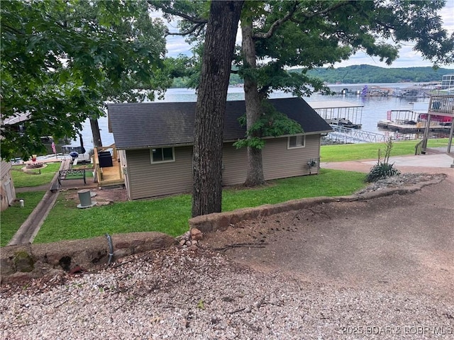35 Knotty Pine Ln, Camdenton, MO 65020 - view of side of home featuring a water view, a lawn, and roof with shingles