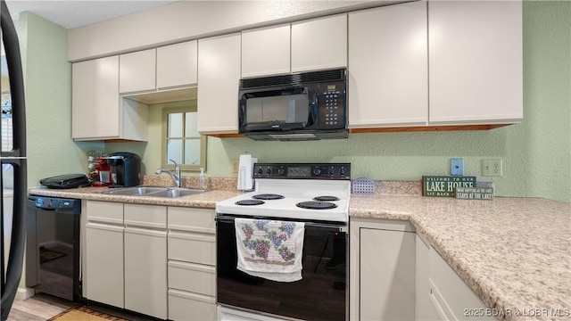 86 Henrys Way Unit 2A, Linn Creek, MO 65052 - kitchen featuring black appliances, a sink, light countertops, white cabinetry, and a textured wall