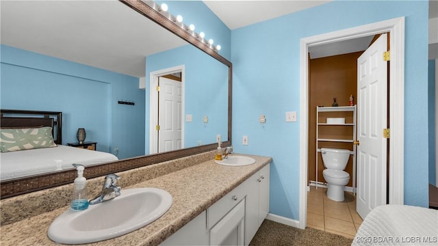 86 Henrys Way Unit 2A, Linn Creek, MO 65052 - full bathroom featuring toilet, double vanity, baseboards, and tile patterned flooring