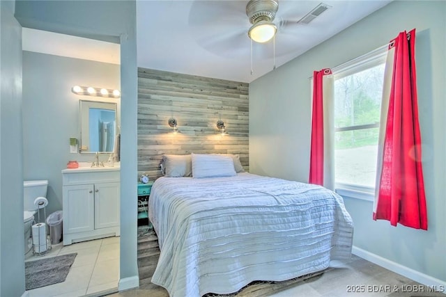 31806 Lakeview Ln, Gravois Mills, MO 65037 - bedroom with ensuite bath, an accent wall, a sink, baseboards, and wooden walls