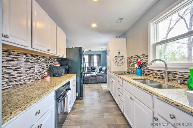 31806 Lakeview Ln, Gravois Mills, MO 65037 - kitchen with black appliances, a sink, white cabinets, decorative backsplash, and recessed lighting