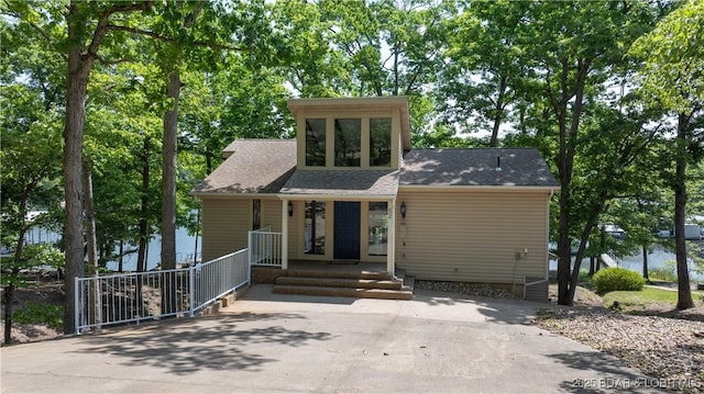 62 Durham Ct, Four Seasons, MO 65049 - view of front of house with a shingled roof, a porch, and concrete driveway