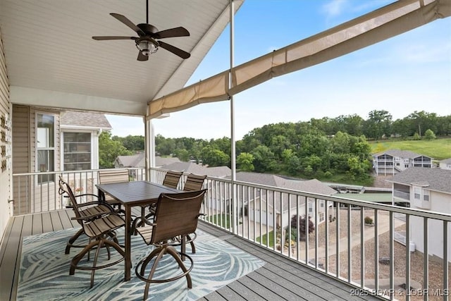879 Great Ship St, Osage Beach, MO 65065 - deck featuring a ceiling fan, view of wooded area, and outdoor dining area