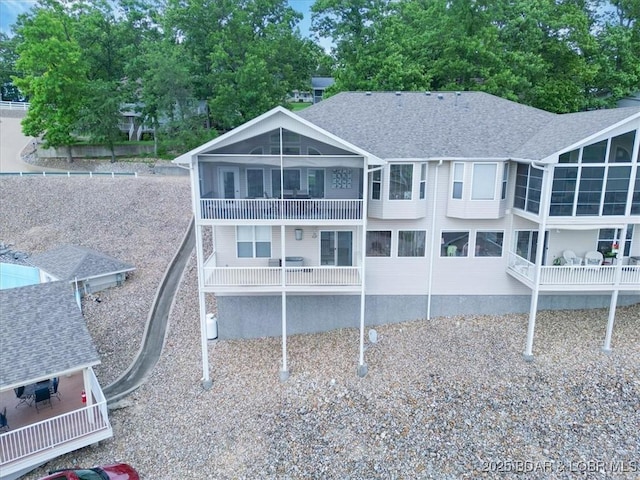 879 Great Ship St, Osage Beach, MO 65065 - rear view of property with a balcony, a sunroom, and a shingled roof