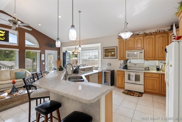 879 Great Ship St, Osage Beach, MO 65065 - kitchen featuring white appliances, a sink, light tile patterned flooring, a ceiling fan, and a kitchen bar