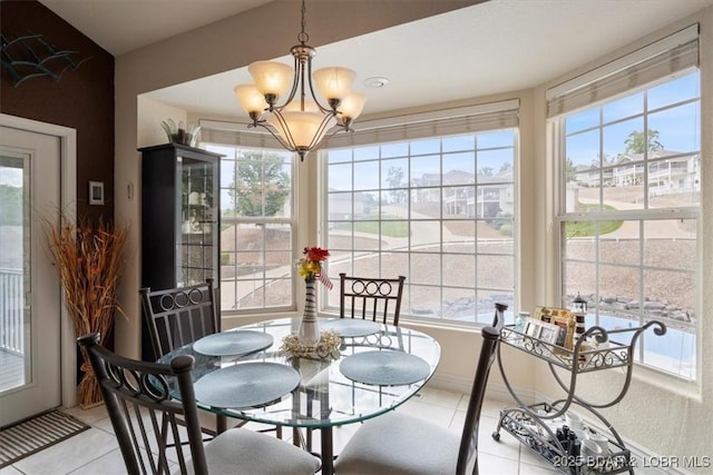 879 Great Ship St, Osage Beach, MO 65065 - dining area with light tile patterned floors, healthy amount of natural light, and a chandelier