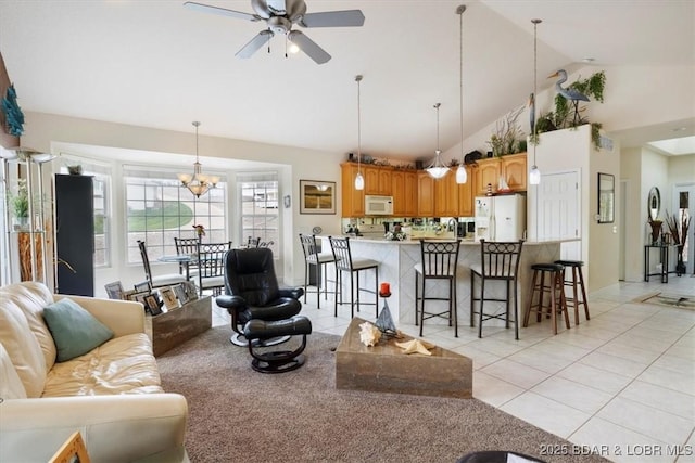 879 Great Ship St, Osage Beach, MO 65065 - living area with light tile patterned flooring, ceiling fan, high vaulted ceiling, and a chandelier