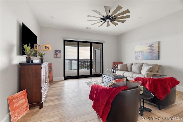 166 Captiva Dr Unit 8B, Sunrise Beach, MO 65079 - living room with baseboards, light wood-style floors, and a ceiling fan