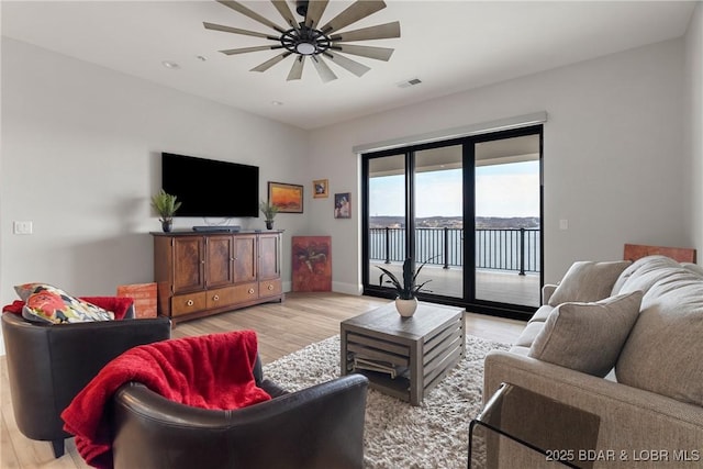 166 Captiva Dr Unit 8B, Sunrise Beach, MO 65079 - living room featuring light wood-type flooring, baseboards, and ceiling fan