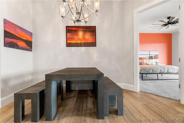 166 Captiva Dr Unit 8B, Sunrise Beach, MO 65079 - dining space with wood finished floors, a chandelier, baseboards, and a ceiling fan