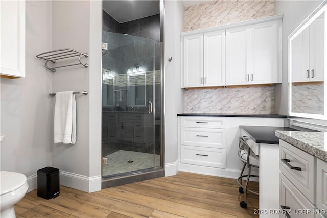 166 Captiva Dr Unit 8B, Sunrise Beach, MO 65079 - full bath featuring a shower stall, wood finished floors, toilet, and baseboards