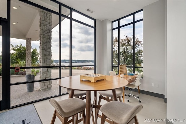166 Captiva Dr Unit 8B, Sunrise Beach, MO 65079 - dining space with a wall of windows