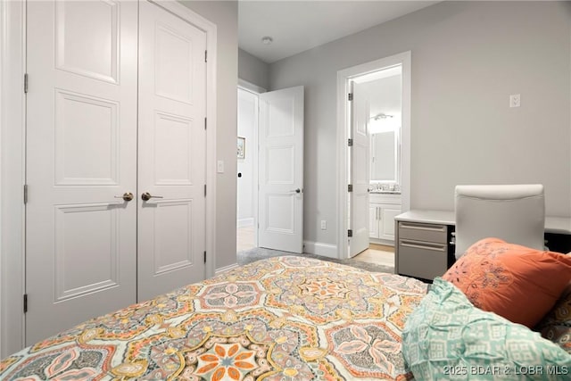 166 Captiva Dr Unit 8B, Sunrise Beach, MO 65079 - bedroom featuring a closet, ensuite bathroom, baseboards, light wood-style floors, and a sink
