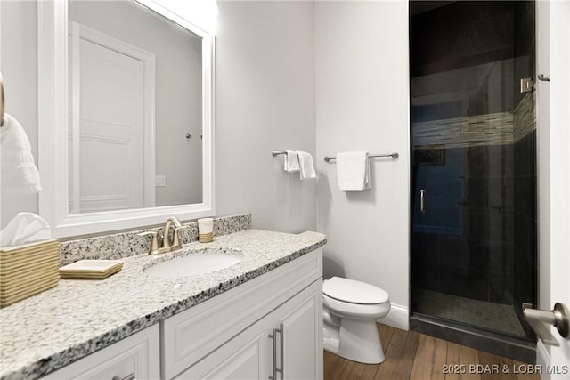 166 Captiva Dr Unit 8B, Sunrise Beach, MO 65079 - full bathroom with vanity, a shower stall, toilet, and wood finished floors