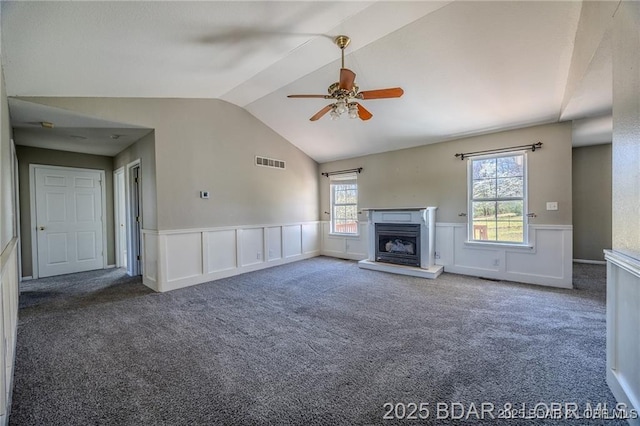 20715 Hiltner Ln, Saint Robert, MO 65584 - unfurnished living room with a wainscoted wall, lofted ceiling, carpet flooring, a ceiling fan, and plenty of natural light