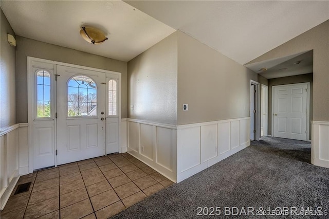 20715 Hiltner Ln, Saint Robert, MO 65584 - carpeted foyer entrance with wainscoting, a decorative wall, and tile patterned flooring