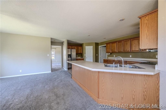 20715 Hiltner Ln, Saint Robert, MO 65584 - kitchen with stainless steel fridge, light colored carpet, a sink, baseboards, and a peninsula