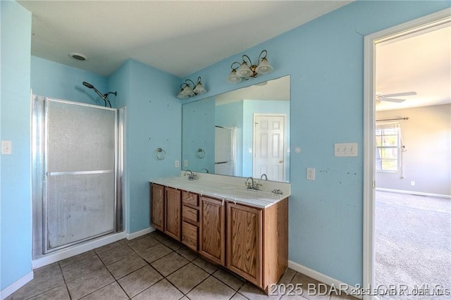 20715 Hiltner Ln, Saint Robert, MO 65584 - bathroom with a shower stall, double vanity, baseboards, and tile patterned flooring