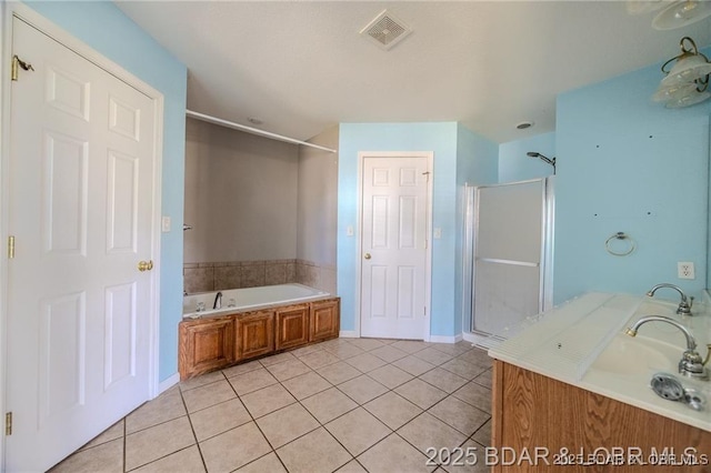 20715 Hiltner Ln, Saint Robert, MO 65584 - full bathroom with tile patterned flooring, a stall shower, a garden tub, vanity, and baseboards
