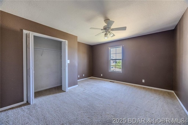 20715 Hiltner Ln, Saint Robert, MO 65584 - unfurnished bedroom with carpet floors, a textured ceiling, baseboards, a ceiling fan, and a closet