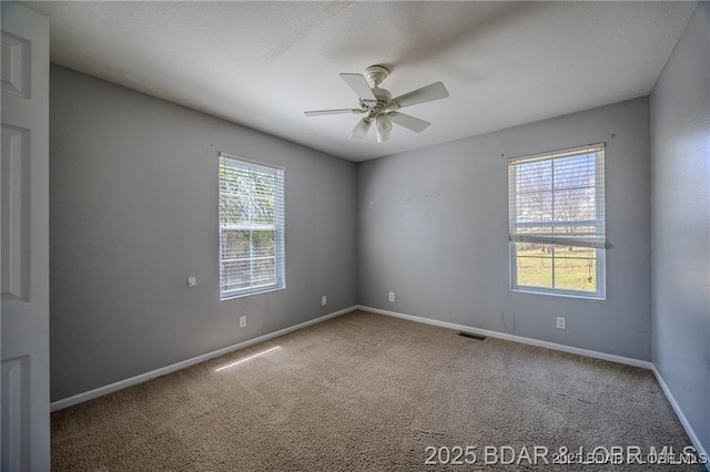 20715 Hiltner Ln, Saint Robert, MO 65584 - spare room featuring carpet floors, baseboards, and ceiling fan