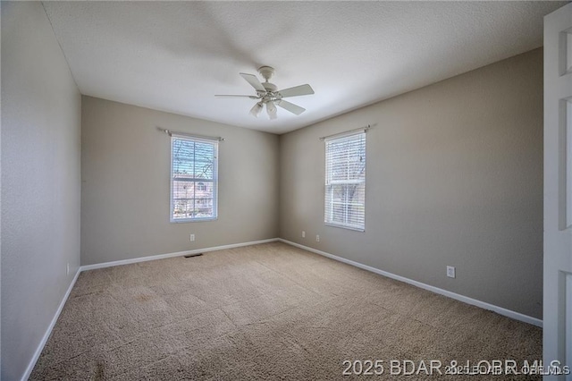 20715 Hiltner Ln, Saint Robert, MO 65584 - spare room featuring ceiling fan, carpet floors, and baseboards