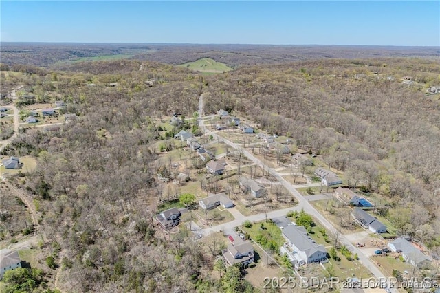 20715 Hiltner Ln, Saint Robert, MO 65584 - aerial view of property and surrounding area featuring a heavily wooded area and nearby suburban area