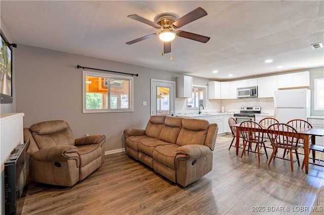 30734 Ottersway Rd, Gravois Mills, MO 65037 - living area with wood finished floors, a ceiling fan, recessed lighting, and baseboards