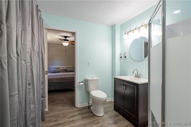 30734 Ottersway Rd, Gravois Mills, MO 65037 - ensuite bathroom featuring wood finished floors, toilet, ceiling fan, and vanity