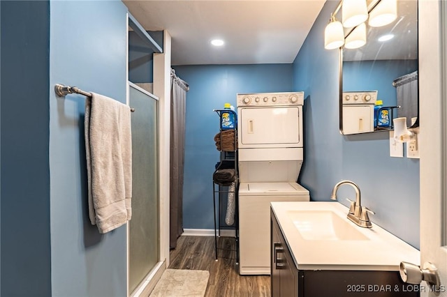 30734 Ottersway Rd, Gravois Mills, MO 65037 - bathroom featuring stacked washer / dryer, a shower stall, wood finished floors, vanity, and baseboards