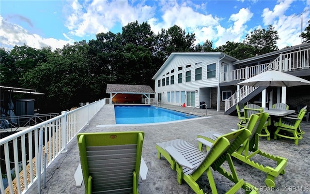 637 Shawnee Four Dr, Sunrise Beach, MO 65079 - view of pool featuring a patio area, a deck, stairs, and an outbuilding