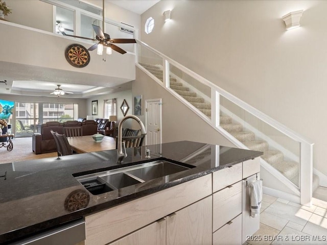 335 Charleston Dr Unit 3B, Lake Ozark, MO 65049 - kitchen with a ceiling fan, a sink, dark stone counters, white cabinetry, and open floor plan
