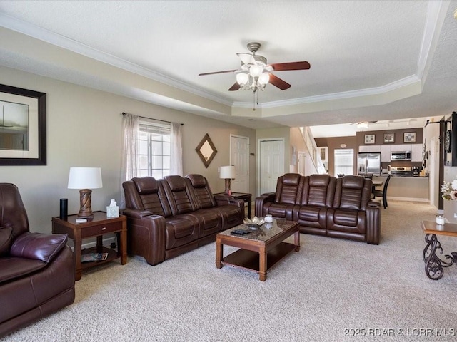 335 Charleston Dr Unit 3B, Lake Ozark, MO 65049 - living room with light colored carpet, a tray ceiling, ornamental molding, and a ceiling fan