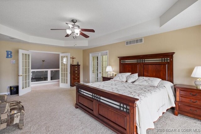 335 Charleston Dr Unit 3B, Lake Ozark, MO 65049 - bedroom featuring french doors, light colored carpet, ceiling fan, and a raised ceiling