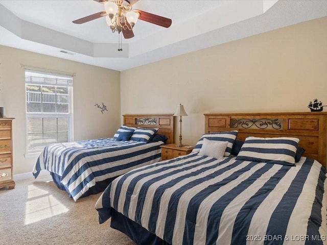 335 Charleston Dr Unit 3B, Lake Ozark, MO 65049 - carpeted bedroom featuring a tray ceiling, a ceiling fan, and baseboards