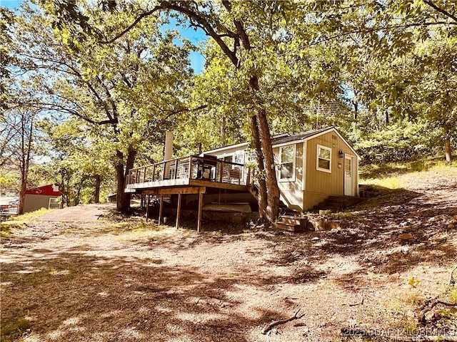 33722 Waterfront Dr, Stover, MO 64078 - view of side of property featuring a deck and view of wooded area