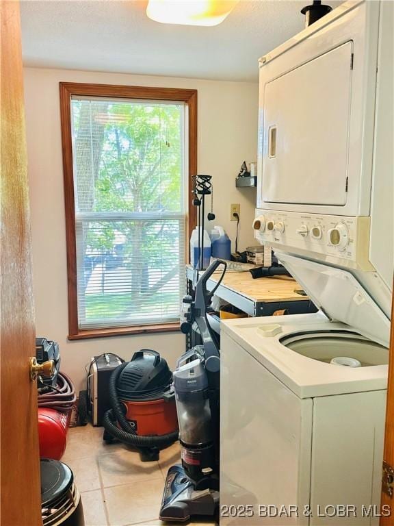 33722 Waterfront Dr, Stover, MO 64078 - laundry room with stacked washing machine and dryer and tile patterned floors