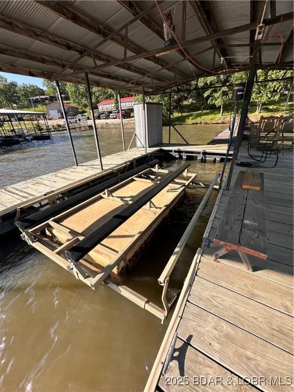 33722 Waterfront Dr, Stover, MO 64078 - dock featuring boat lift and a water view
